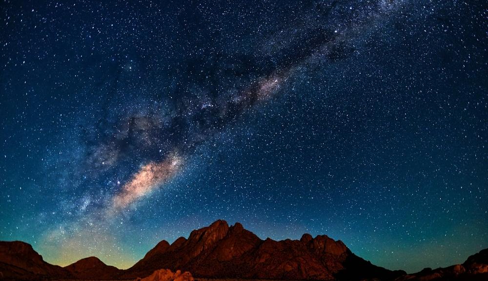 Milky Way galaxy over mountains in the distance. A picture to emphasize the nightlife at Zion National Park.
